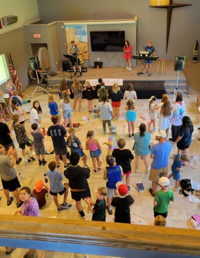 Looking down at a room full of kids at summer Christian camp.